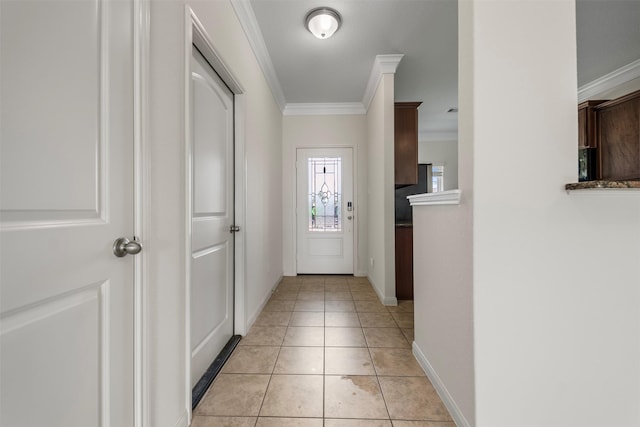 doorway to outside featuring crown molding, baseboards, and light tile patterned floors