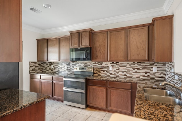 kitchen featuring visible vents, crown molding, black microwave, range with two ovens, and a sink