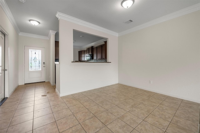 entrance foyer with crown molding, light tile patterned flooring, baseboards, and visible vents