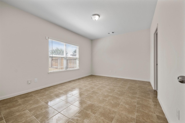 unfurnished room featuring visible vents, baseboards, and light tile patterned flooring