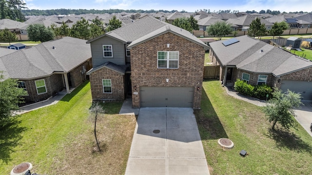 view of front of home with a residential view, an attached garage, a front lawn, brick siding, and concrete driveway