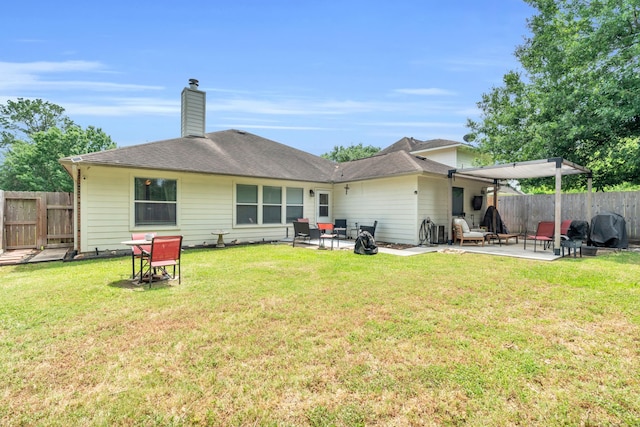 9114 Colony Cove Dr, Spring, TX 77379 - rear view of house with a fenced backyard, a patio area, a yard, and a chimney