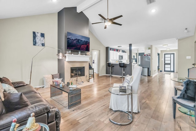 9114 Colony Cove Dr, Spring, TX 77379 - living room featuring light wood-type flooring, ceiling fan, a fireplace, and beamed ceiling