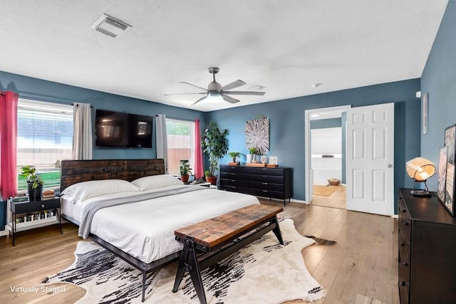 9114 Colony Cove Dr, Spring, TX 77379 - bedroom featuring ceiling fan, visible vents, ensuite bathroom, and light wood-type flooring
