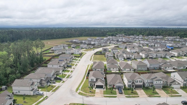 drone / aerial view featuring a view of trees and a residential view