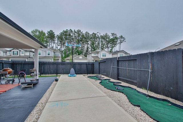 view of patio / terrace featuring a fenced backyard and a residential view