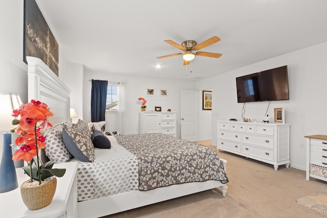 bedroom featuring baseboards, ceiling fan, and light colored carpet