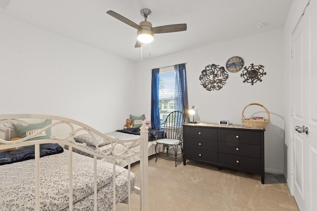 bedroom featuring baseboards, ceiling fan, and light carpet