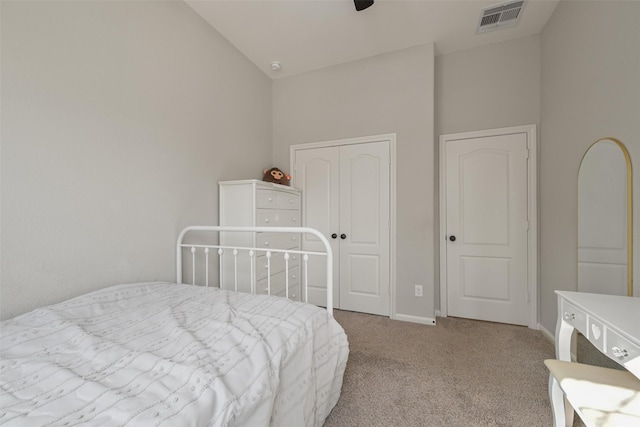 bedroom featuring visible vents, baseboards, high vaulted ceiling, a closet, and carpet flooring