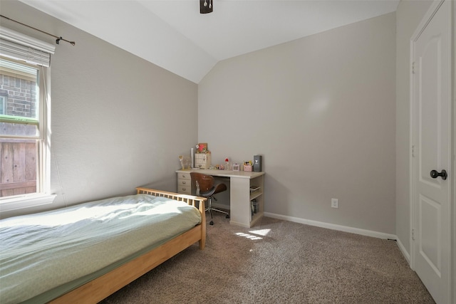 carpeted bedroom with baseboards and vaulted ceiling
