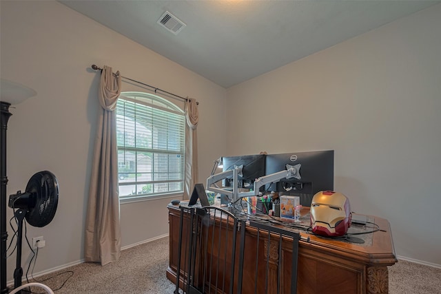 office space with baseboards, visible vents, and light carpet