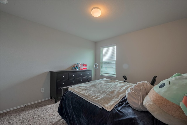 bedroom featuring baseboards and carpet