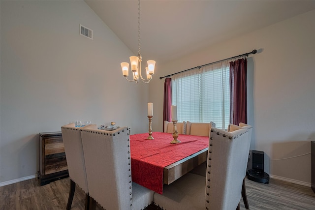 dining room featuring visible vents, baseboards, wood finished floors, and an inviting chandelier