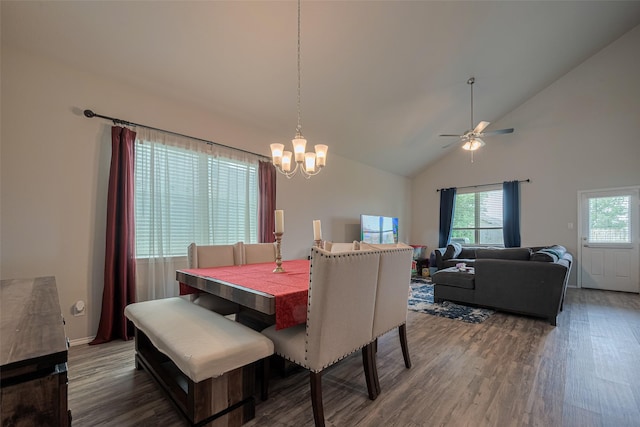 dining area with high vaulted ceiling, wood finished floors, and ceiling fan with notable chandelier