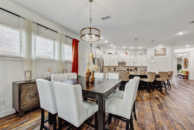 dining space featuring visible vents, recessed lighting, dark wood-style flooring, and a notable chandelier