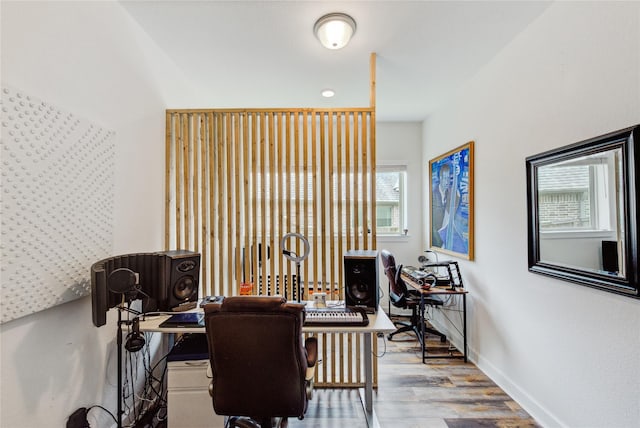 home office featuring baseboards and wood finished floors
