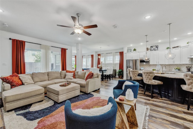 living room with recessed lighting, ceiling fan, visible vents, and light wood-type flooring