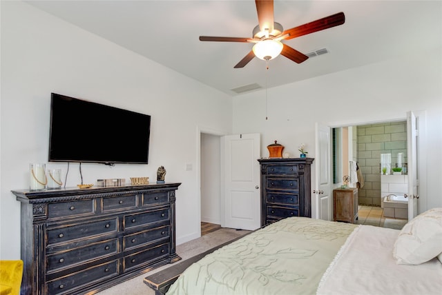 bedroom featuring connected bathroom, a ceiling fan, and visible vents