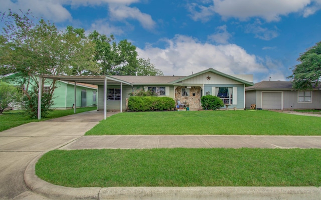 ranch-style house with an attached garage, driveway, a front yard, and a carport