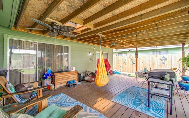 deck with a ceiling fan and fence