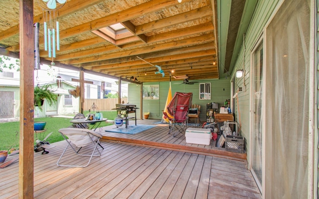 deck featuring a yard, ceiling fan, and fence