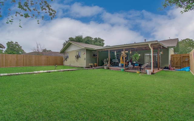 rear view of property with a fenced backyard, a patio area, and a yard