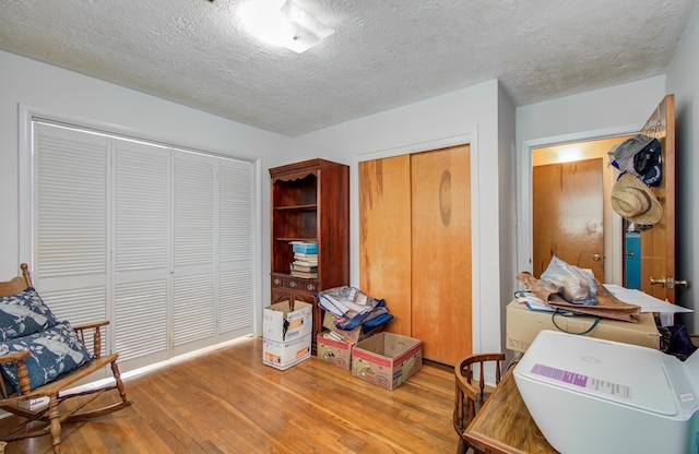 sitting room featuring a textured ceiling and wood finished floors