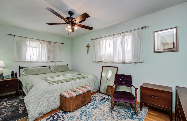 bedroom with a ceiling fan and wood finished floors