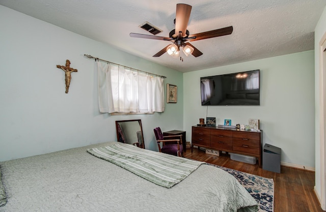 bedroom featuring visible vents, a ceiling fan, and wood finished floors