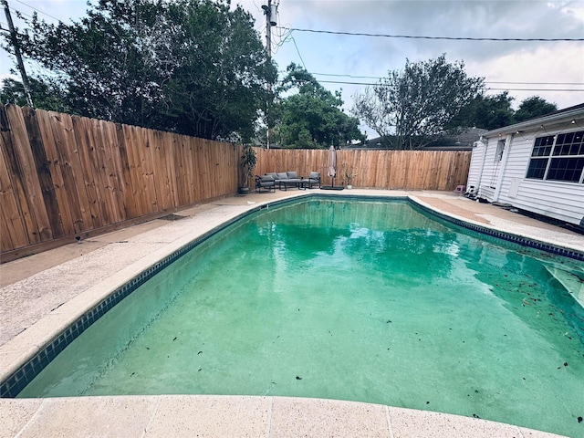 view of pool with a fenced in pool, a fenced backyard, a patio area, and an outdoor hangout area