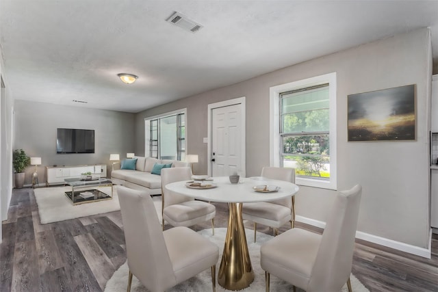 dining room with baseboards, dark wood-style floors, and visible vents