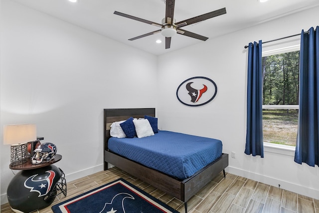 bedroom with recessed lighting, wood finish floors, ceiling fan, and baseboards