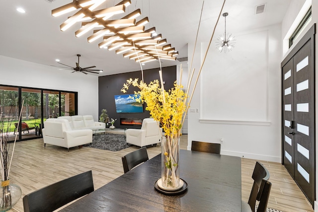 dining area with a ceiling fan, visible vents, baseboards, light wood finished floors, and recessed lighting