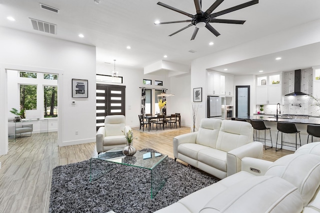 living room with recessed lighting, a ceiling fan, and visible vents
