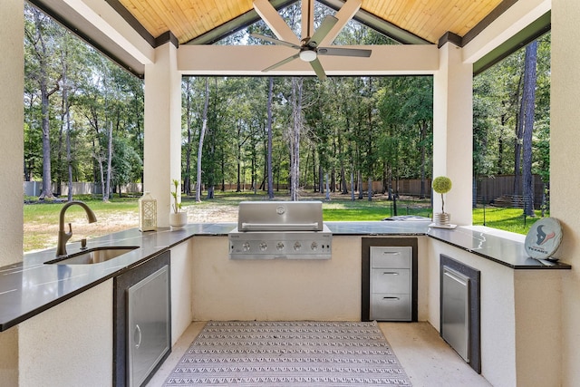 view of patio with area for grilling, ceiling fan, fence, and a sink