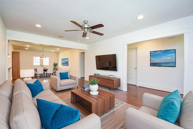 1406 Foxwood Rd, Houston, TX 77008 - living area featuring visible vents, wood finished floors, baseboards, recessed lighting, and ceiling fan with notable chandelier