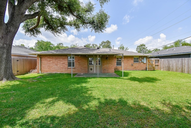 1406 Foxwood Rd, Houston, TX 77008 - back of house with a lawn, brick siding, a fenced backyard, and a patio area