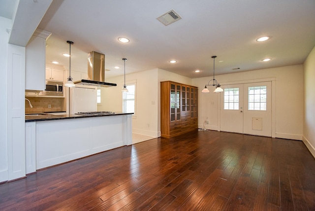 1406 Foxwood Rd, Houston, TX 77008 - unfurnished living room with visible vents, baseboards, dark wood-style floors, recessed lighting, and a sink