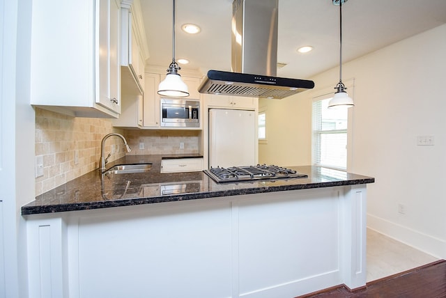 1406 Foxwood Rd, Houston, TX 77008 - kitchen with island range hood, a sink, white cabinets, a peninsula, and stainless steel appliances