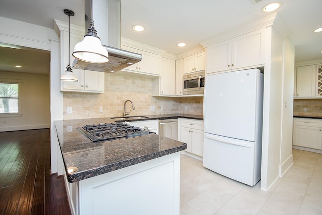 1406 Foxwood Rd, Houston, TX 77008 - kitchen featuring freestanding refrigerator, island range hood, stainless steel microwave, gas stovetop, and a sink