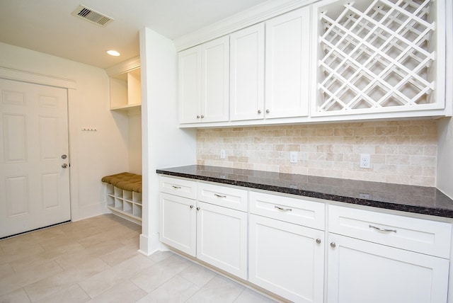 1406 Foxwood Rd, Houston, TX 77008 - kitchen featuring tasteful backsplash, dark stone countertops, and visible vents