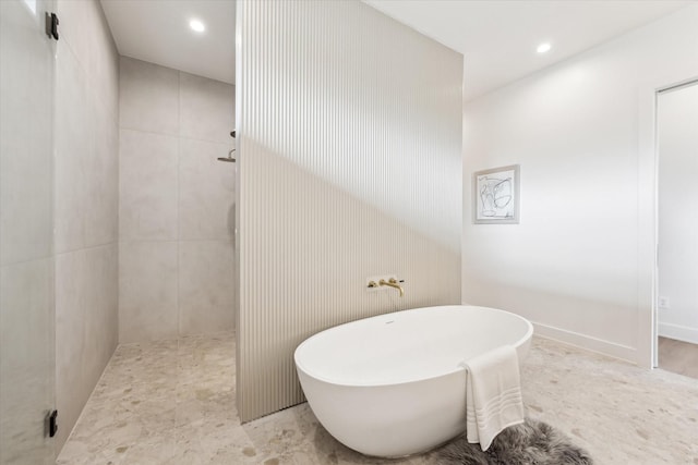 full bath featuring a soaking tub, recessed lighting, and tiled shower
