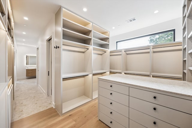 spacious closet with light wood-type flooring and visible vents