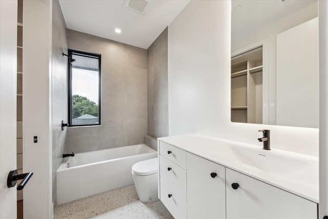 bathroom featuring a tub, visible vents, speckled floor, vanity, and toilet