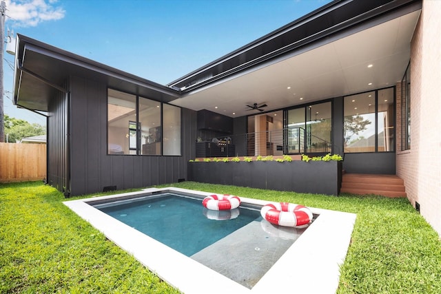 view of pool featuring fence and a yard