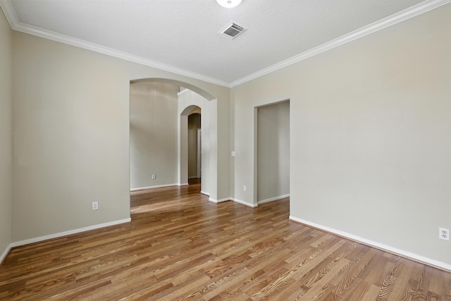 11030 Sprucedale Ct, Houston, TX 77070 - unfurnished room featuring arched walkways, crown molding, wood finished floors, and baseboards