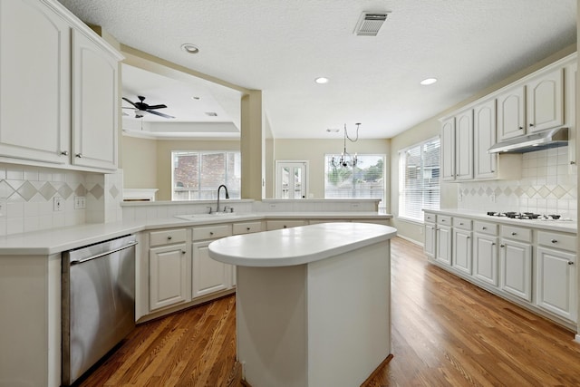 11030 Sprucedale Ct, Houston, TX 77070 - kitchen with dishwasher, under cabinet range hood, a sink, plenty of natural light, and recessed lighting