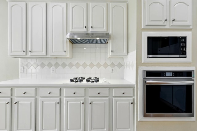 11030 Sprucedale Ct, Houston, TX 77070 - kitchen featuring stainless steel oven, white gas cooktop, under cabinet range hood, built in microwave, and white cabinetry