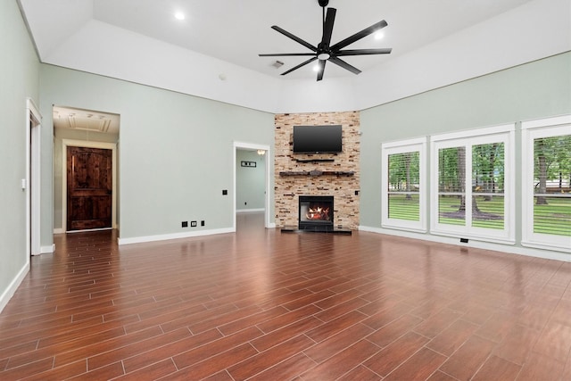 230009 Kama Dr, Porter, TX 77365 - unfurnished living room featuring ceiling fan, baseboards, attic access, and a fireplace