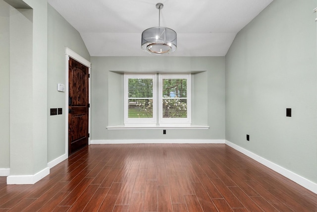 230009 Kama Dr, Porter, TX 77365 - unfurnished dining area with baseboards, an inviting chandelier, wood finished floors, and lofted ceiling